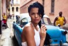 sultry Cuban woman near car
